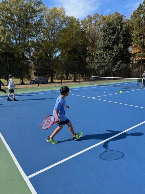 Big NC junior running to hit a forehand