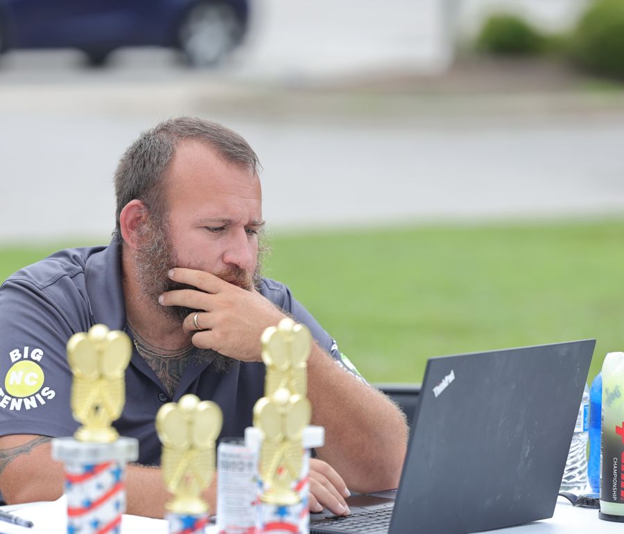 Coach Cole at a Big NC tournament desk