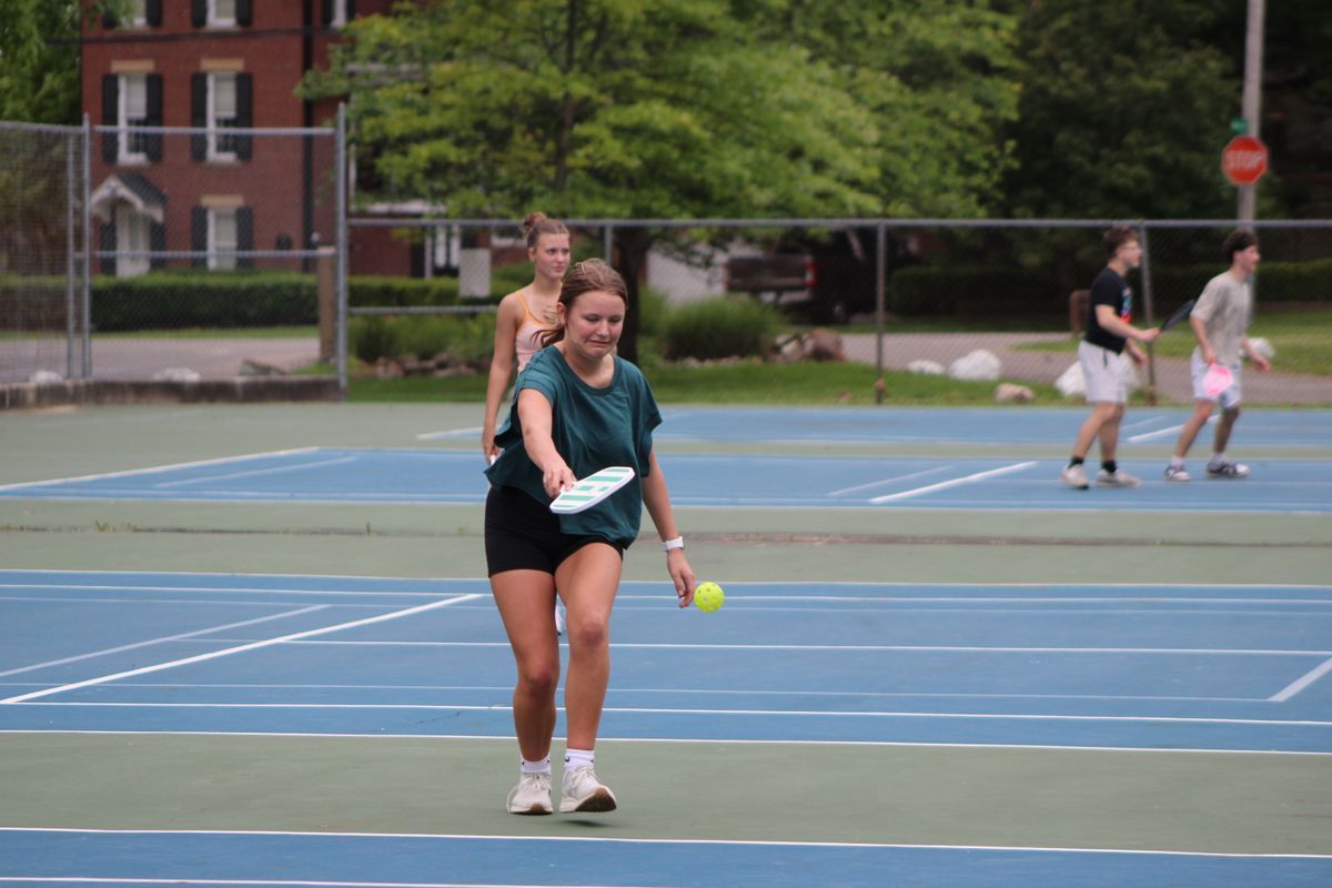 Friends playing pickleball outdoors