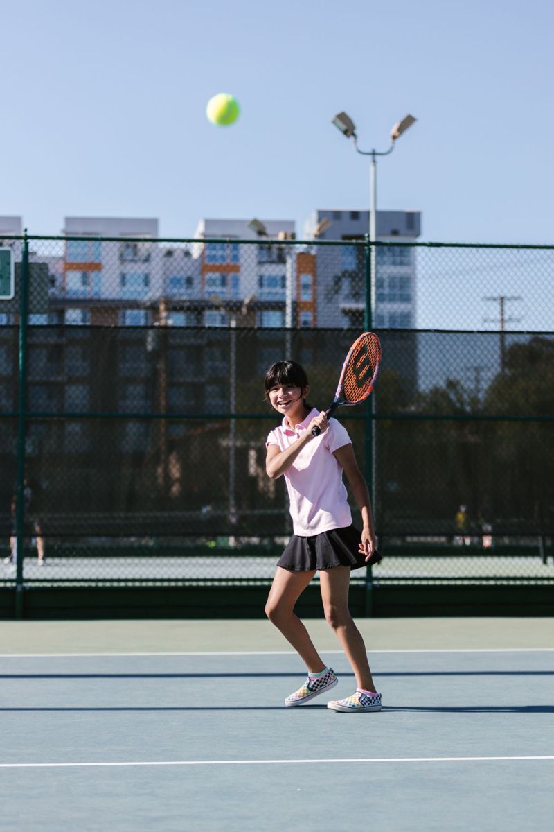 Teen player hitting an overhead