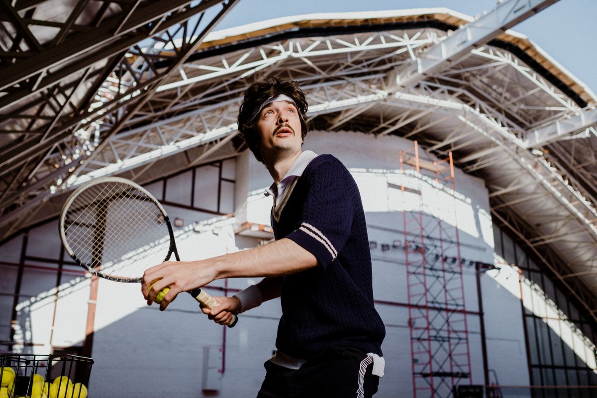 Tennis coach with racket